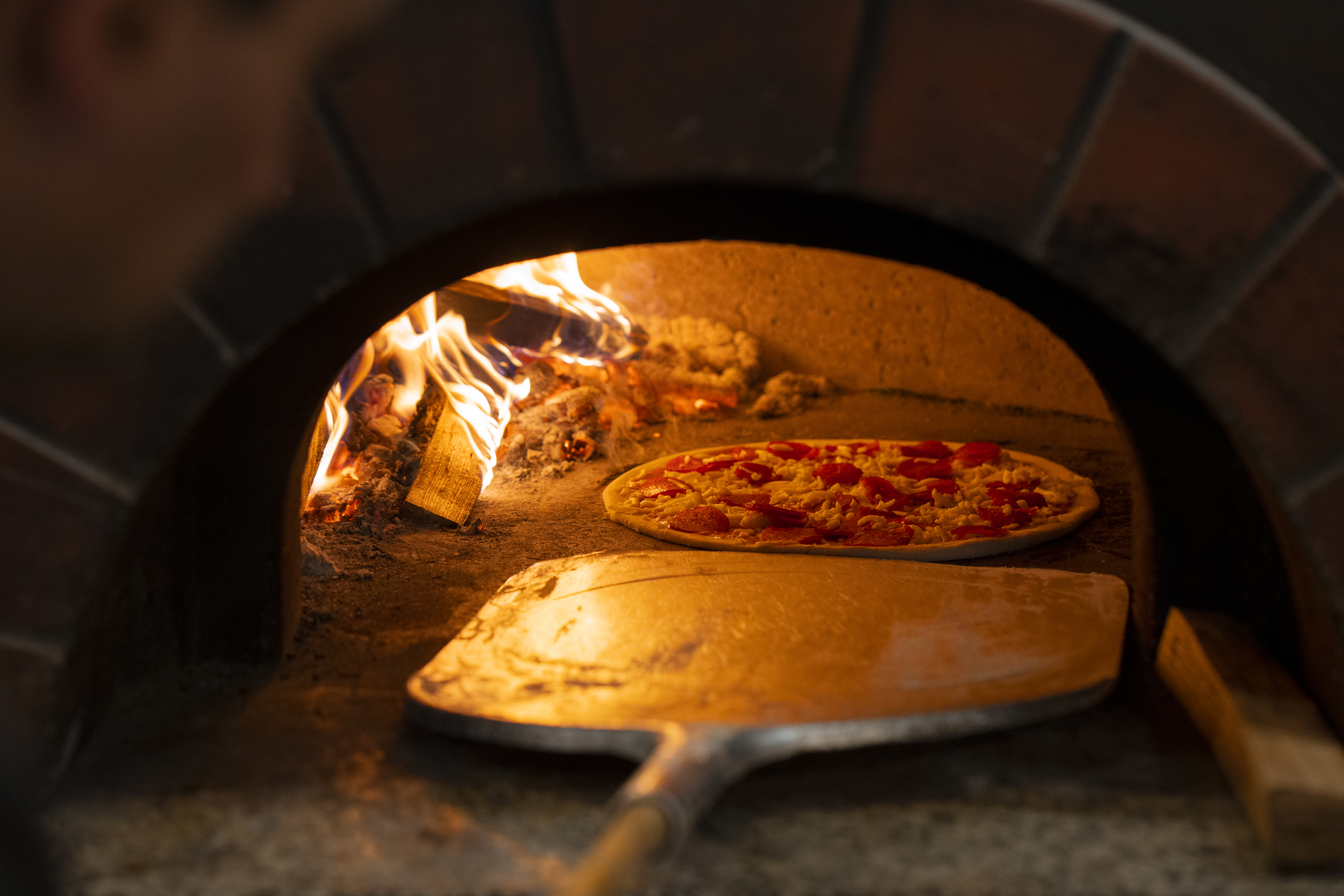 baking delicious pizza with wood fired oven